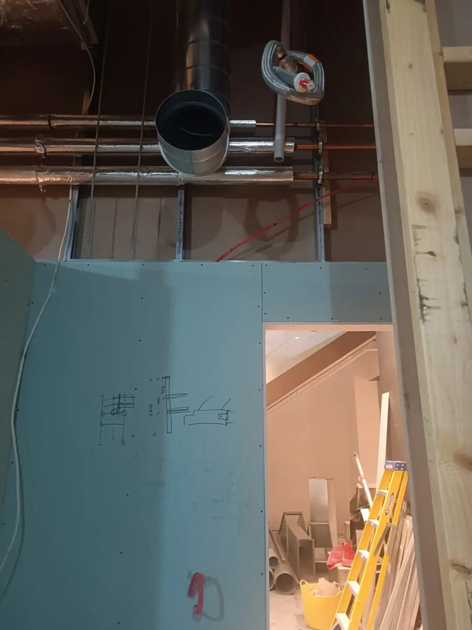 New copper water pipework running at high level through a building riser